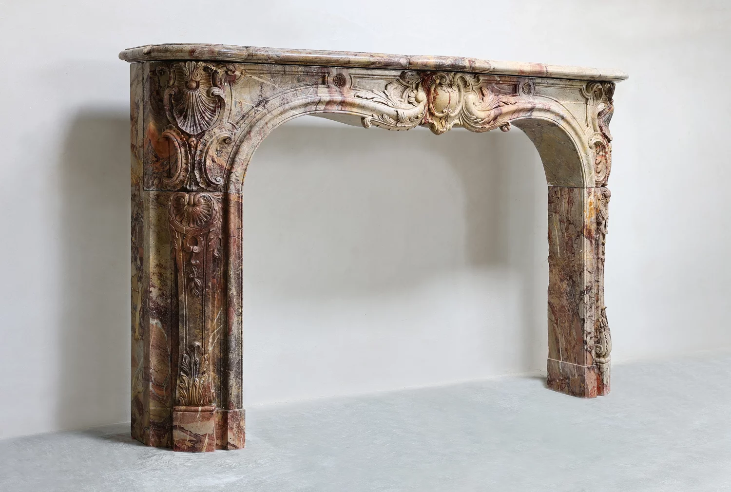 Schrägansicht eines antiken französischen Marmorkamins im Louis-XV-Stil, Kaminmaske aus Sarrancolin-Marmor, professionell restaurierter Vintage Mantle aus Paris